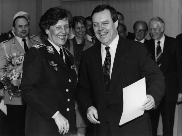 © dpa, Tim Brakemeier, Bonn, 25.3.94: Federal Defense Minister Volker Rühe (r) hands Verena von Weymarn the certificate of promotion to the general.